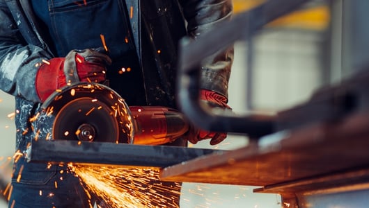 A person cutting metal