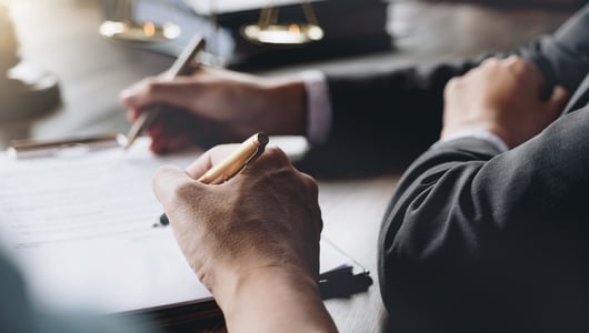People writing on paperwork