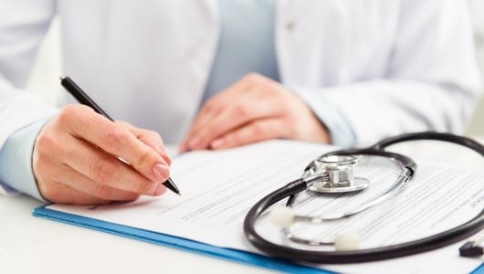 Doctor filling out paperwork