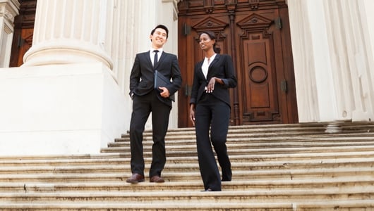 Two people in front of government building